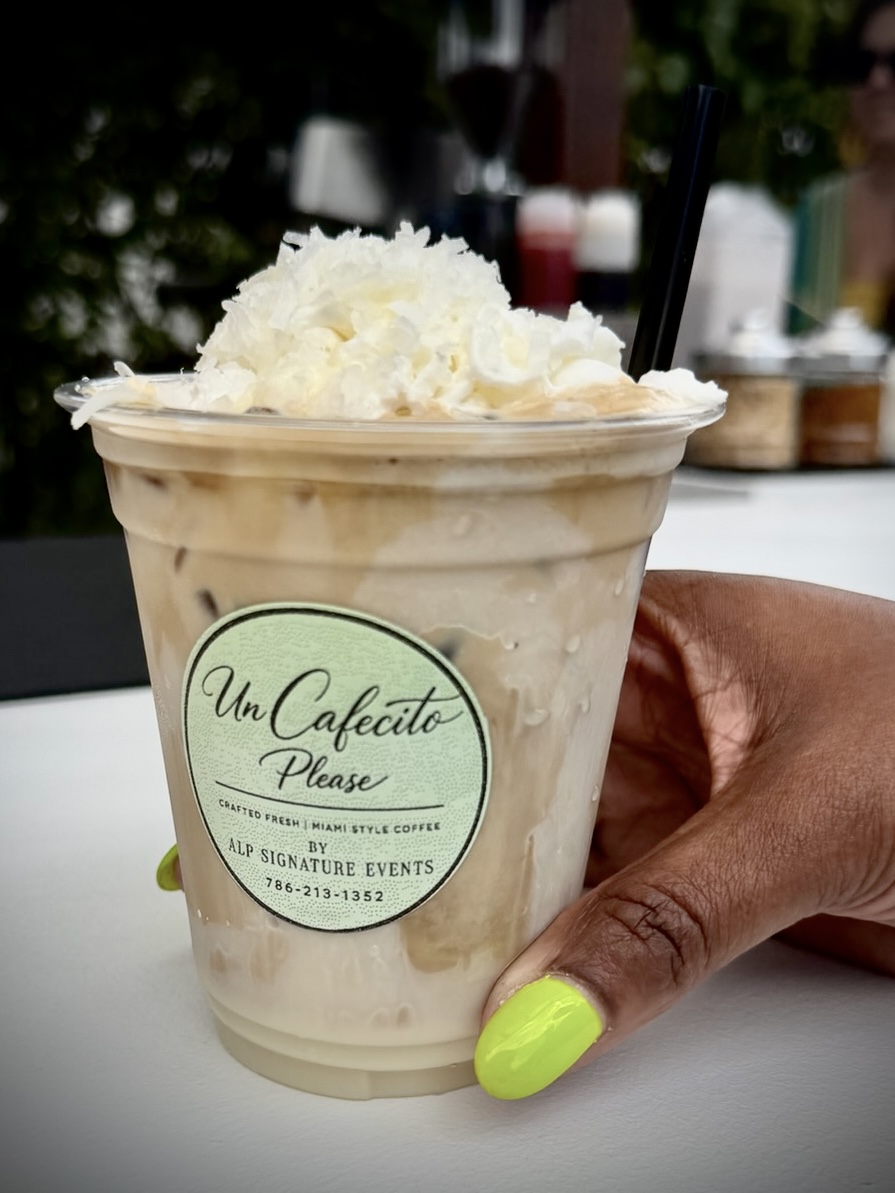 Iced cafecito latte topped with coconut whipped cream